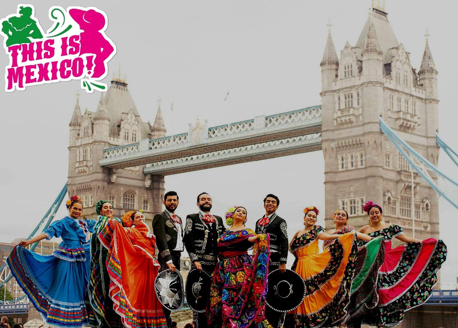 The company in full traditional dance dress in front of Tower Bridge in London.